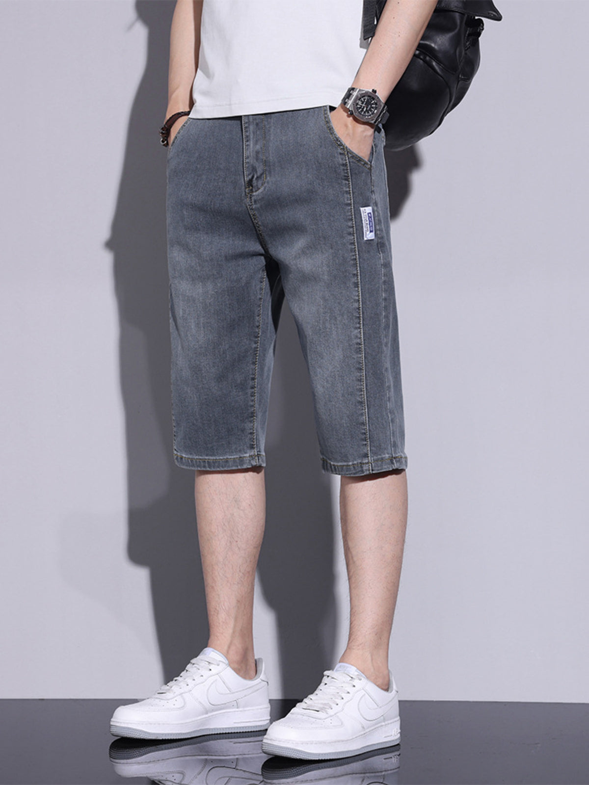 Men's grey washed denim shorts, knee-length, casual cotton.
