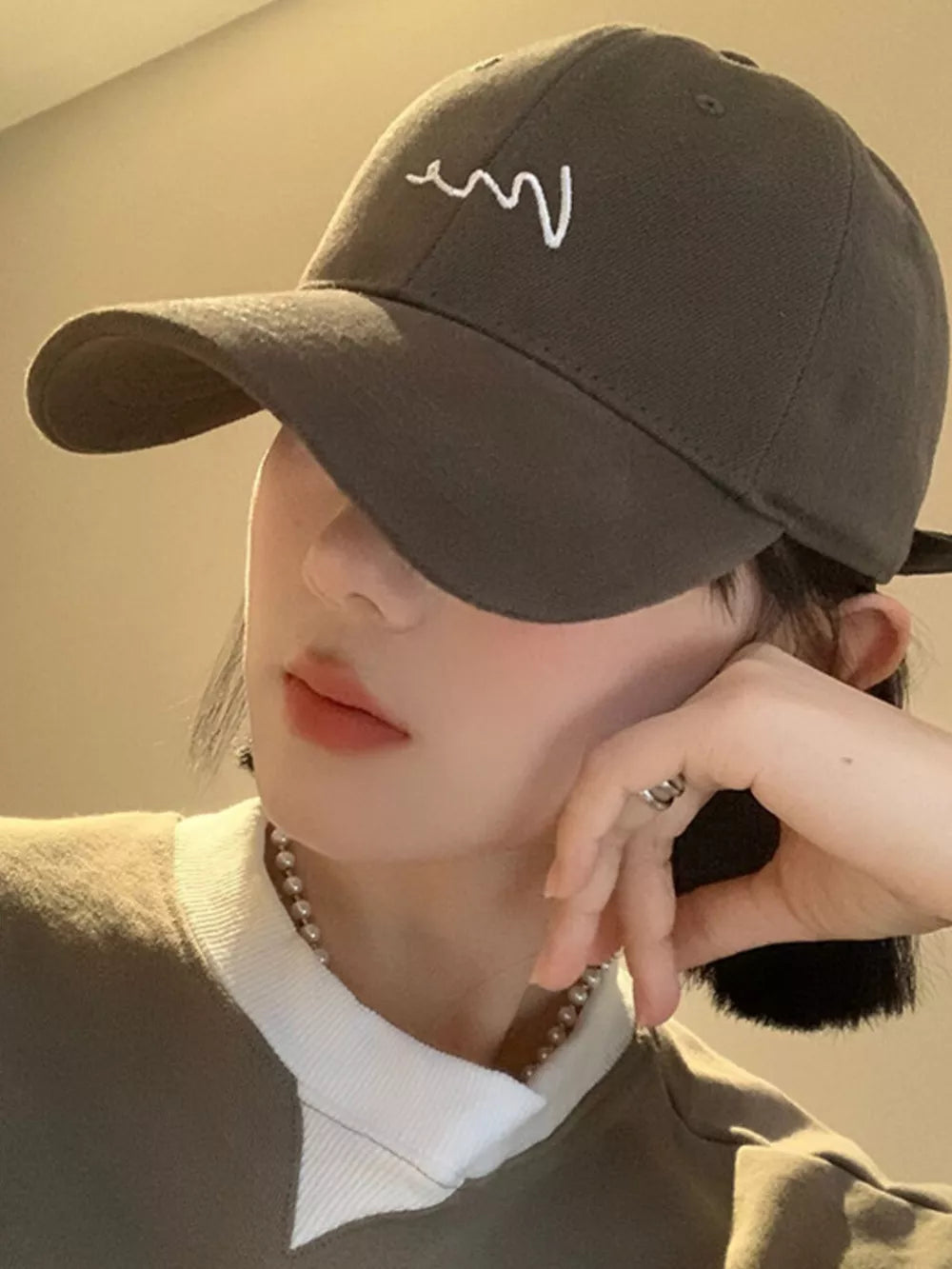 Grey cotton baseball cap with white embroidered wave detail and curved brim