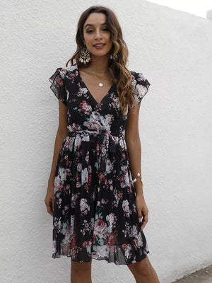 Black floral pleated dress with ruffle sleeves and a V-neck.