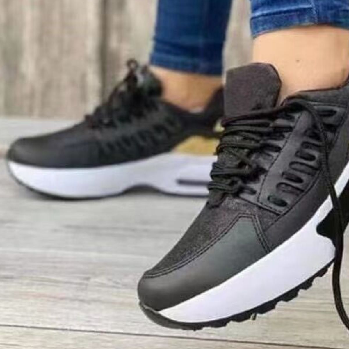 Black lace-up chunky platform sneakers with white soles.