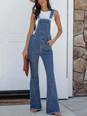 Flared denim overalls in medium wash with raw hem and pocket detail.