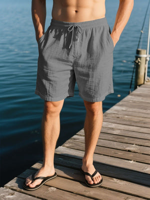 Men's grey drawstring shorts with pockets, elastic waistband, and relaxed fit.
