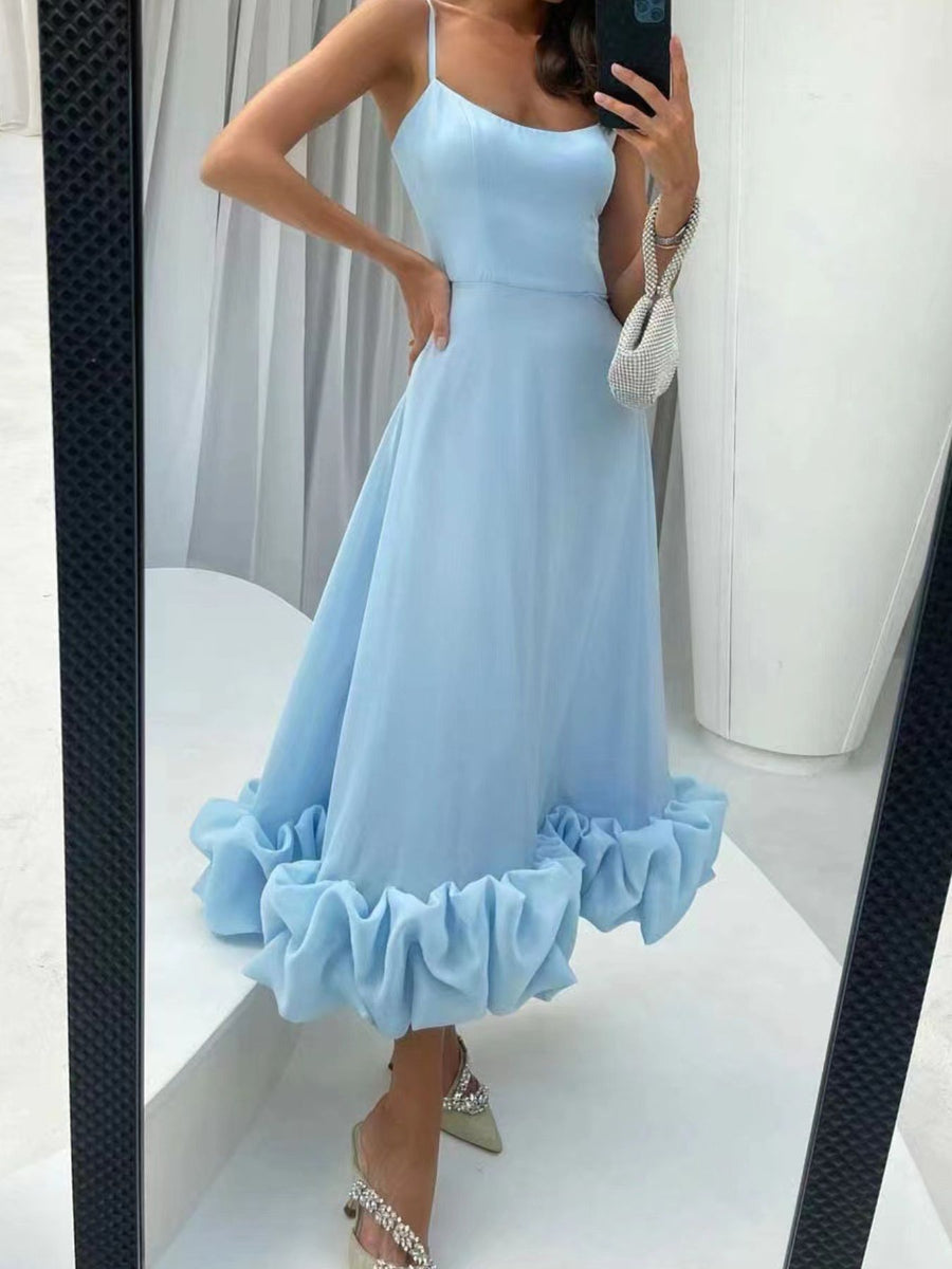 Light blue midi dress with spaghetti straps and a ruffled hem.