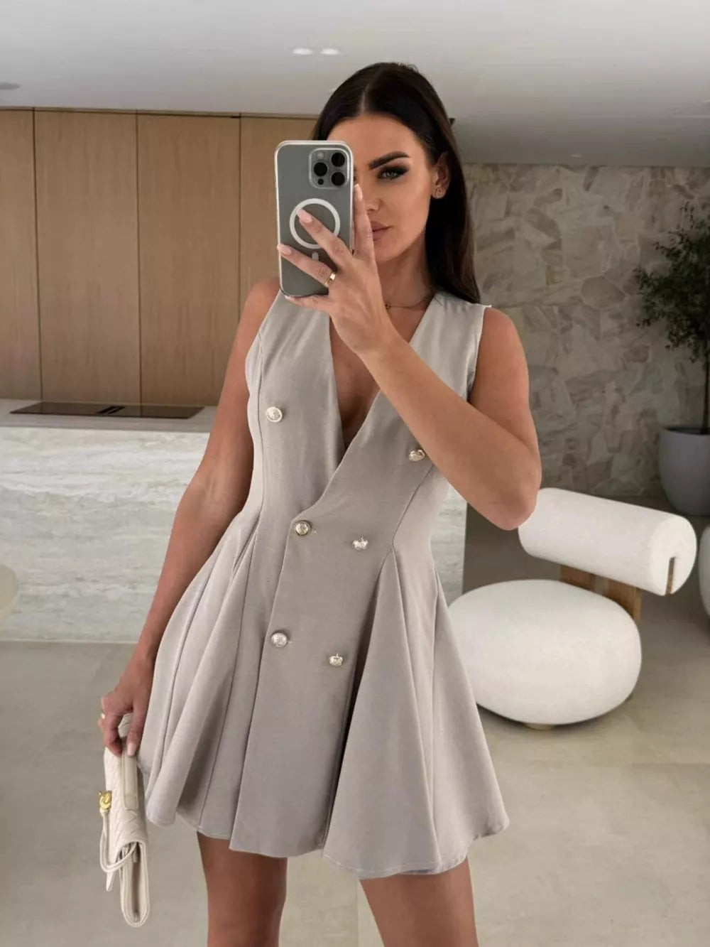 Gray double-breasted mini dress with V-neck, sleeveless, and pleated skirt.