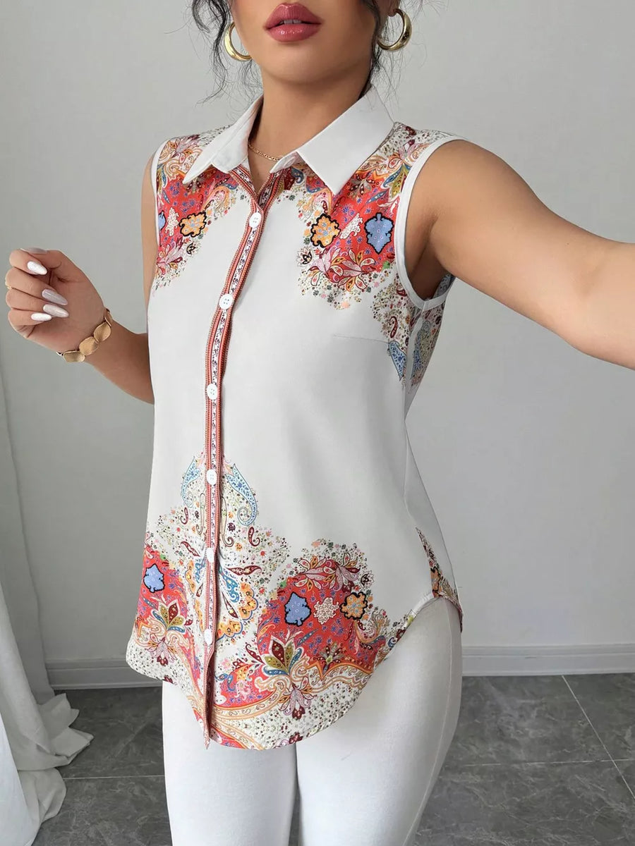 White sleeveless collared shirt with vibrant paisley print and button front.