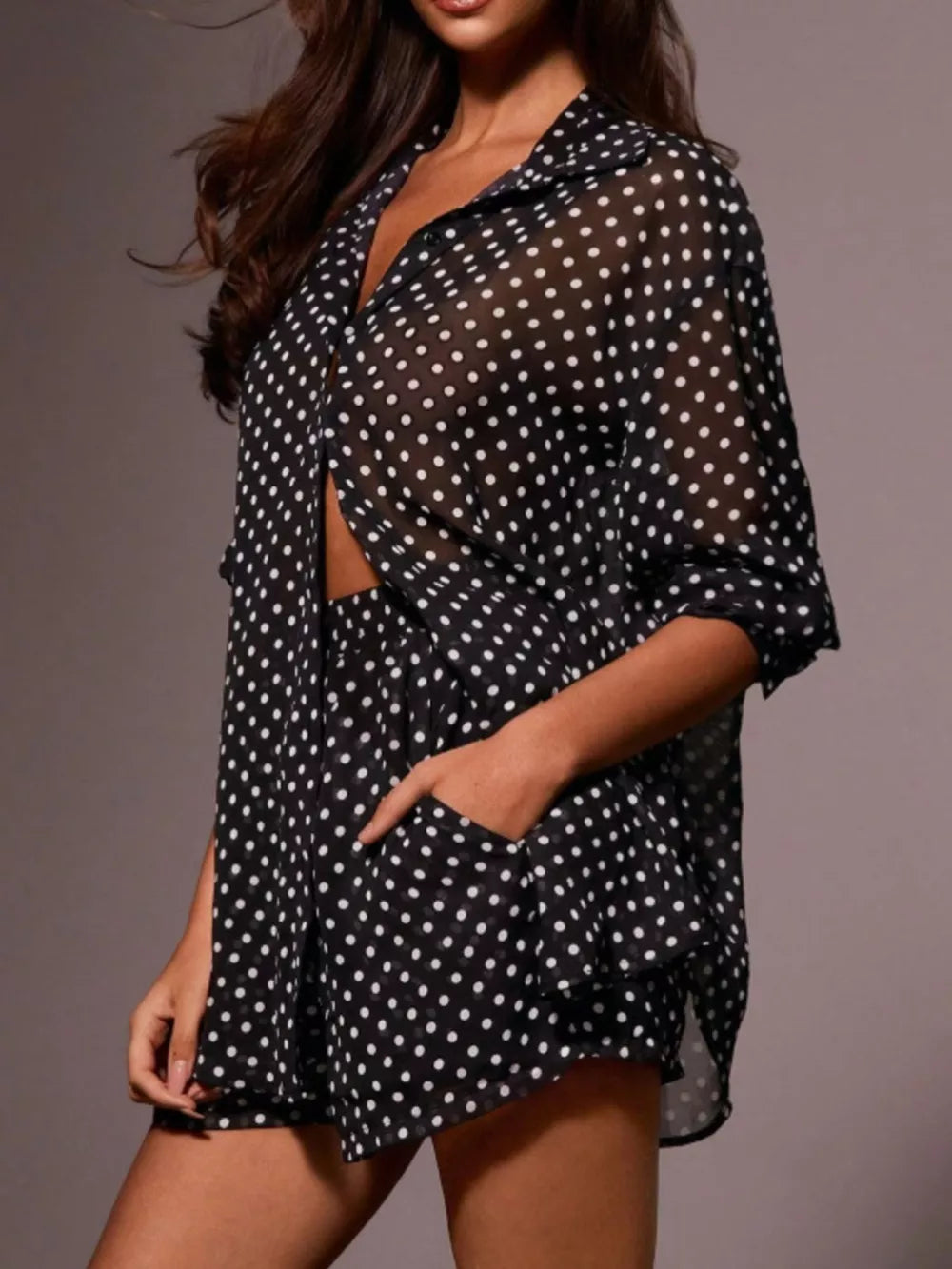 Black sheer polka dot two-piece set with button-up shirt and shorts.