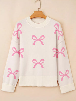 Beige drop shoulder sweater with allover pink bow print, crew neck, and ribbed cuffs and hem.