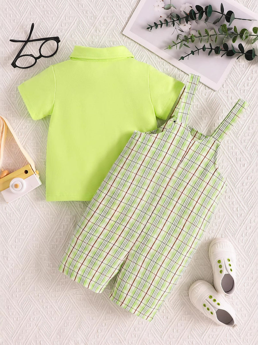 Children's lime green polo shirt and plaid overalls set with adjustable straps.