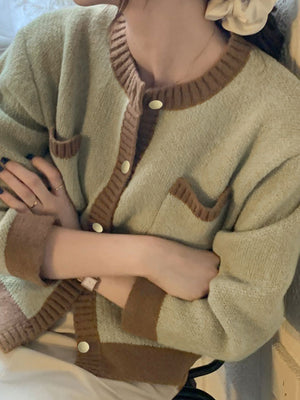 Green acrylic button up cardigan with contrast trim and pockets