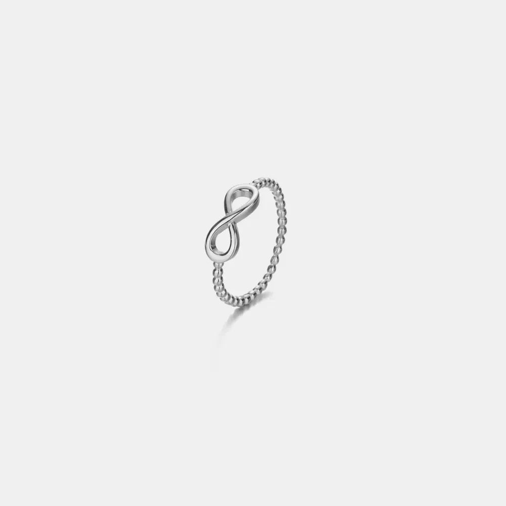 Sterling silver ring with beaded band and infinity symbol detail