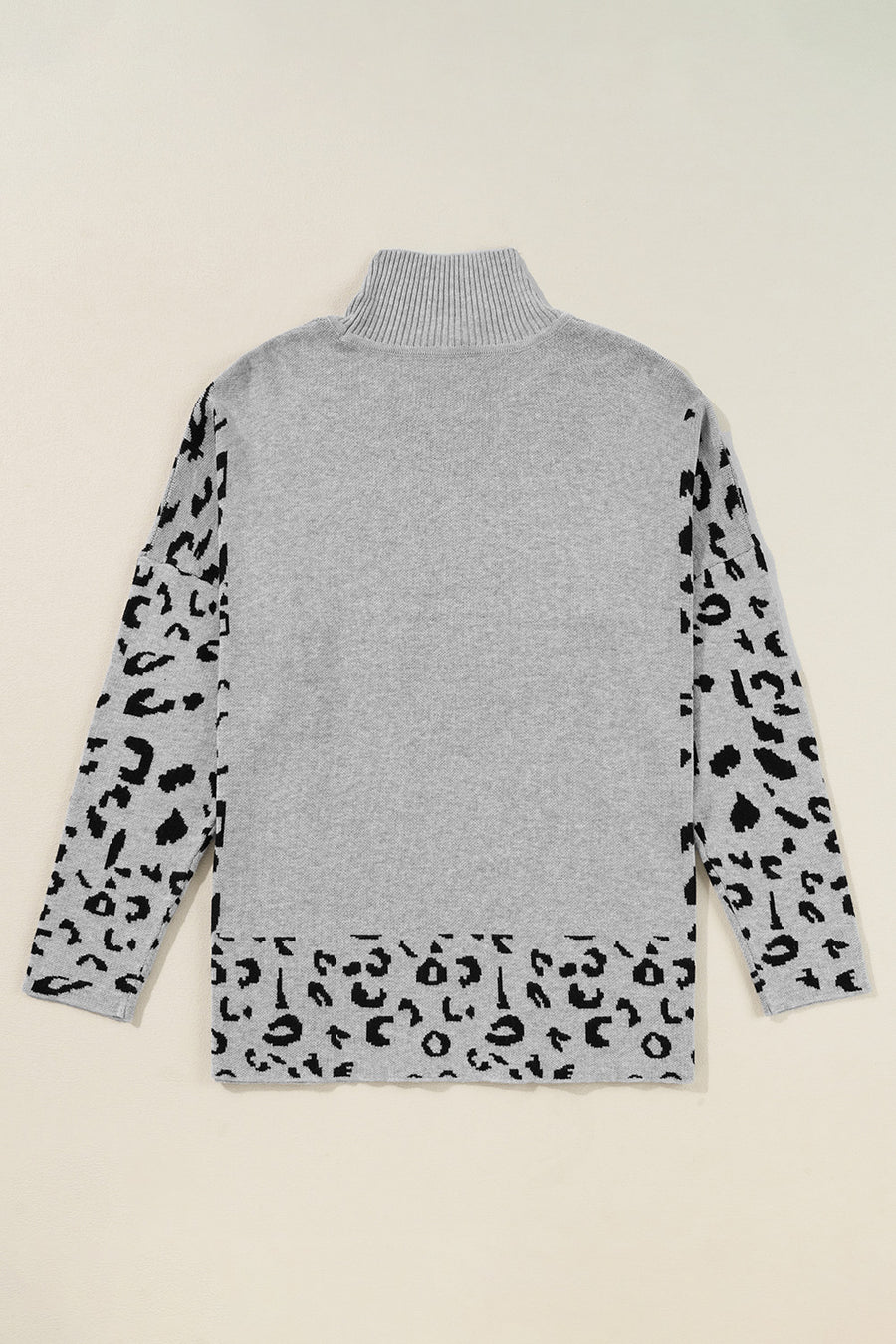 Gray turtleneck sweater with asymmetric leopard print sleeves and hem