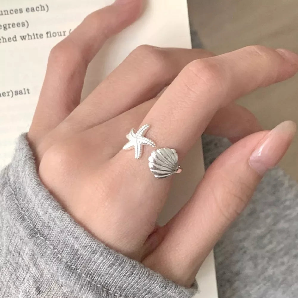silver ring with starfish and seashell motif and not applicable