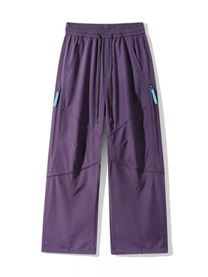 Purple men's cargo pants with drawstring waist and zippered pockets.