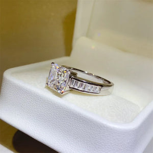 Radiant emerald cut diamond ring with baguette accents in silver.