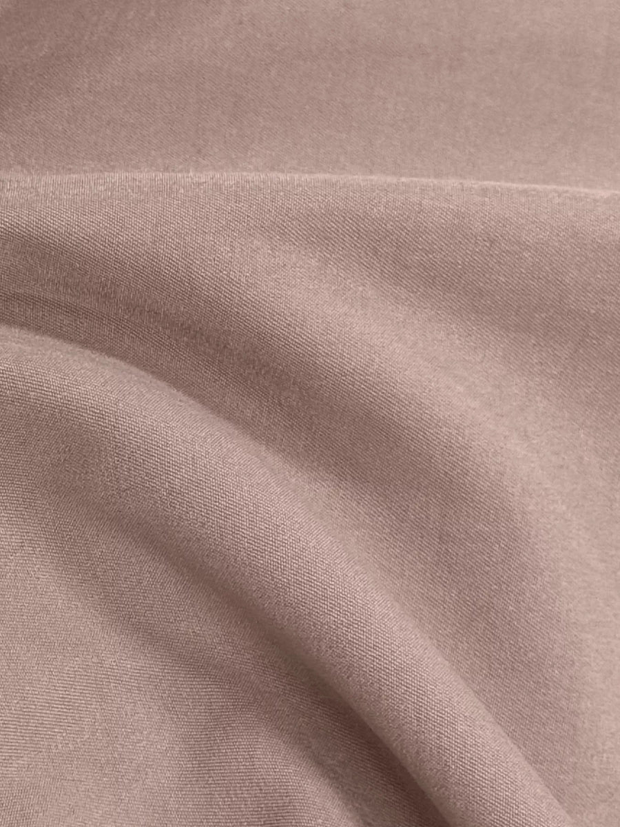 Lightweight open front cardigan in dusty pink, showing fabric texture and drape.