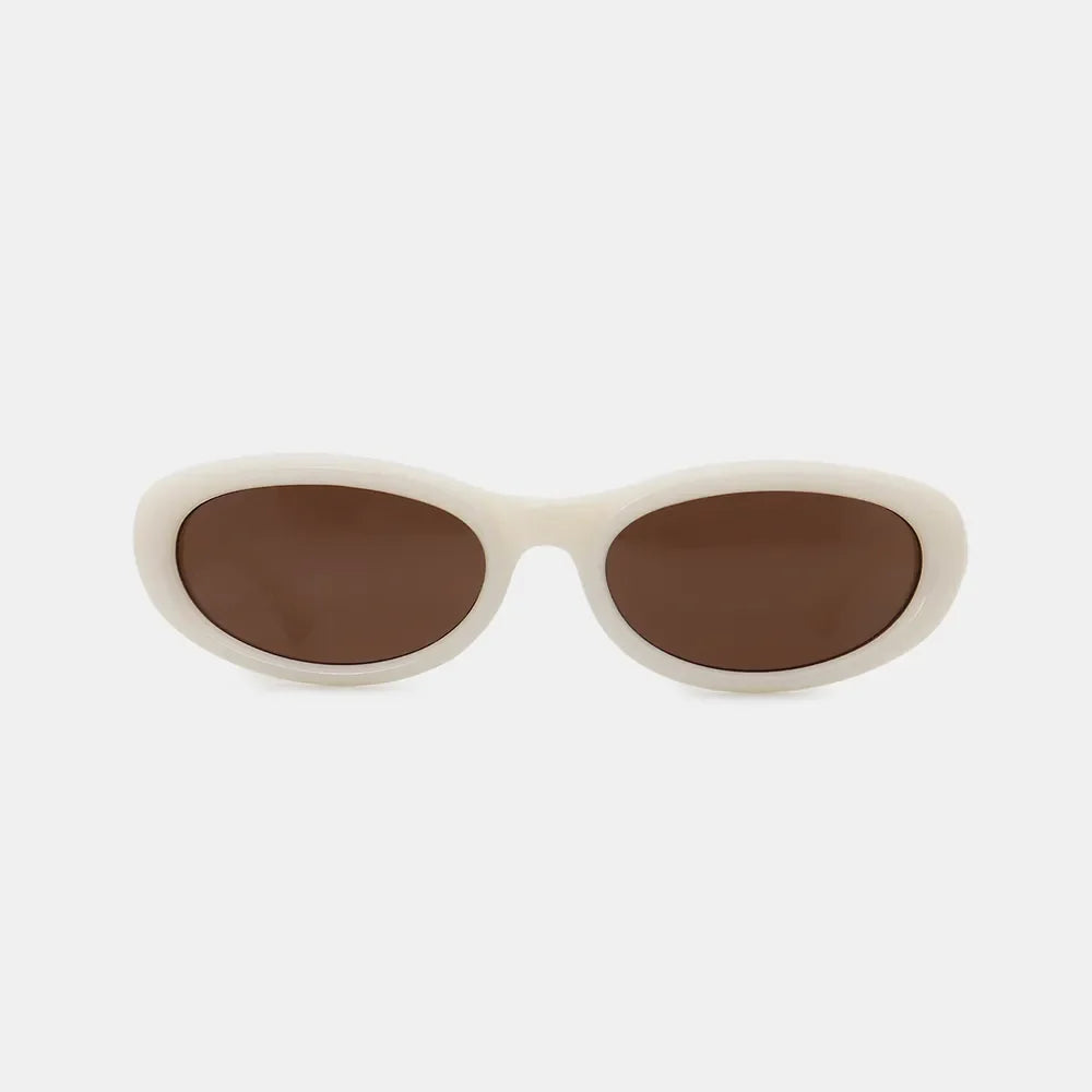 Ivory cat eye sunglasses with brown lenses and thick frames.