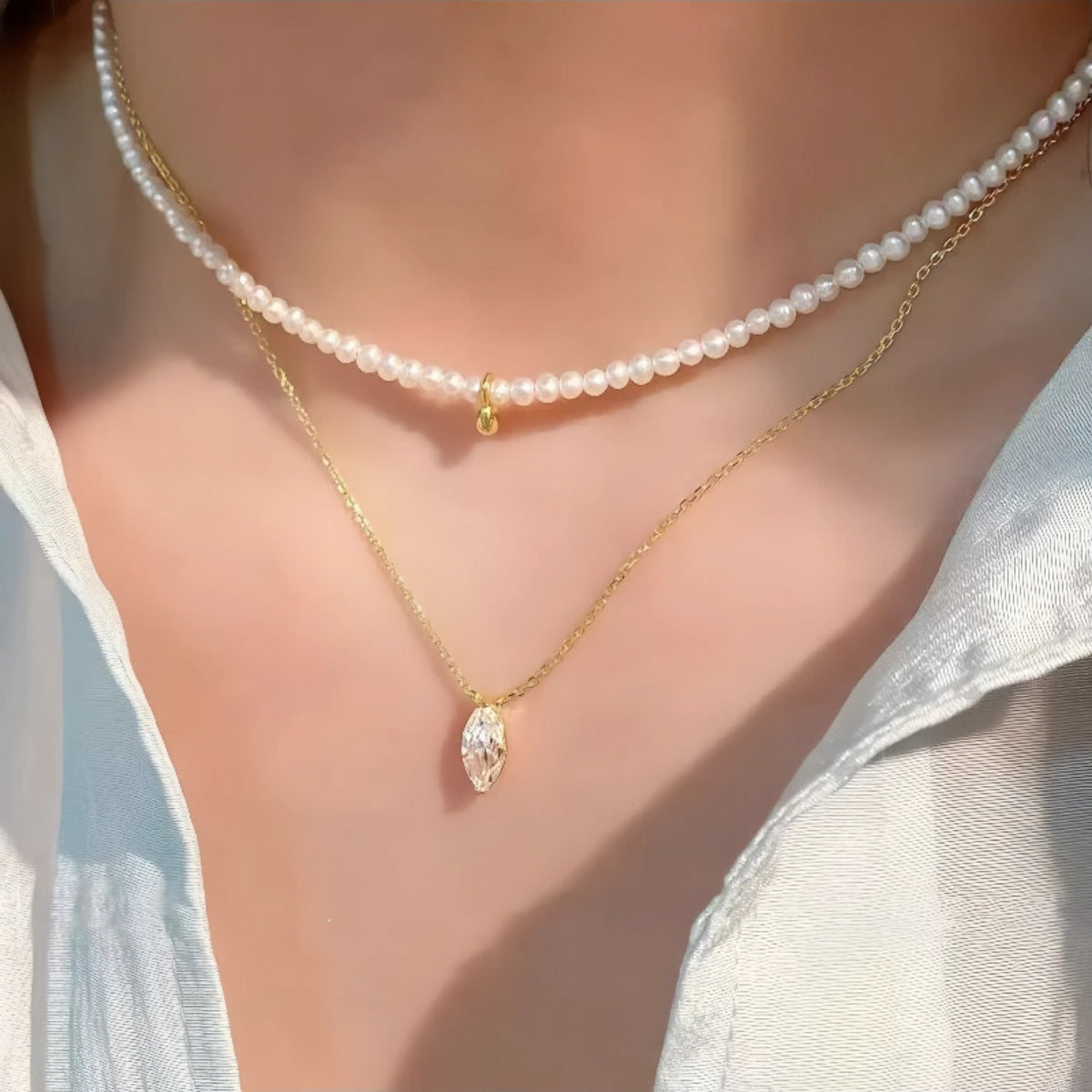 Sterling Zircon pendant necklace with pearl choker, gold chain, and marquise cut crystal.