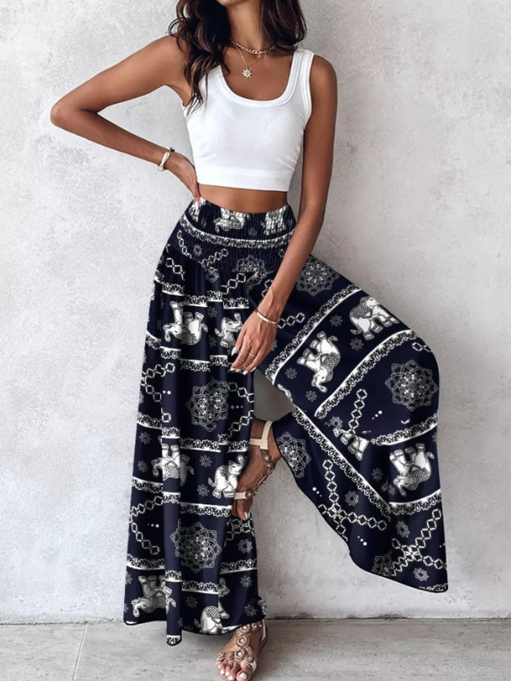 Bohemian print smocked waist wide-leg pants in dark navy with elephant and mandala patterns.