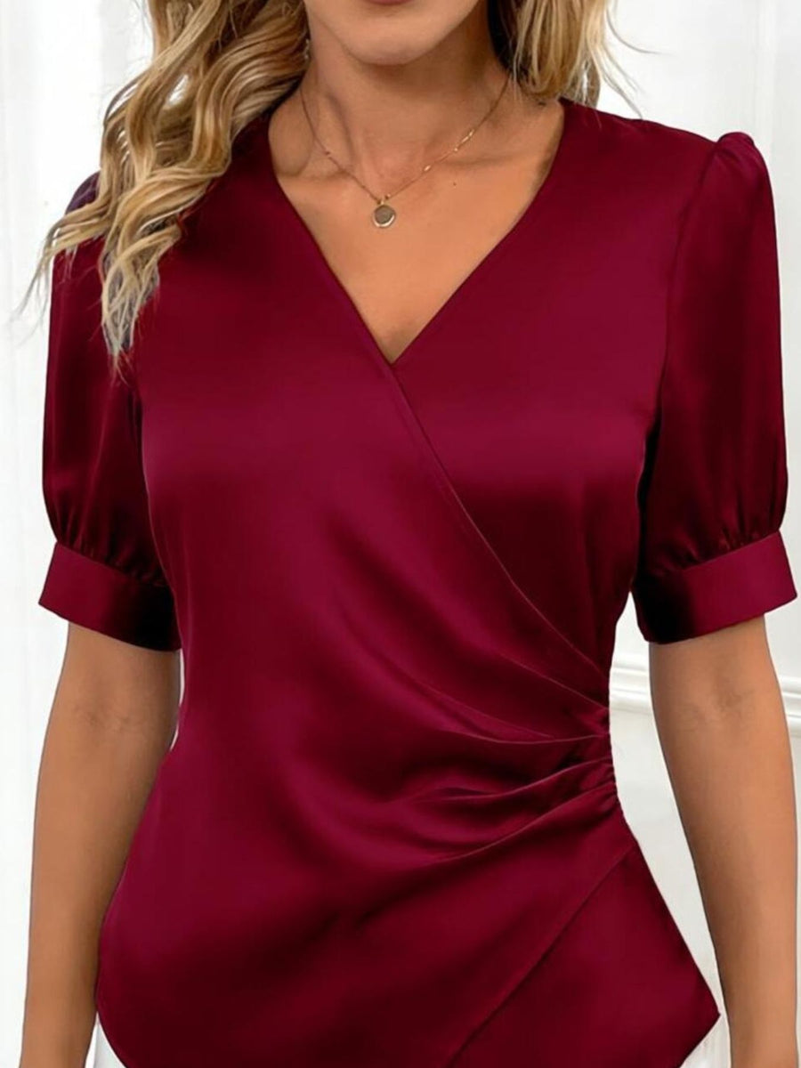 Burgundy satin wrap blouse with ruched side detail and short puff sleeves