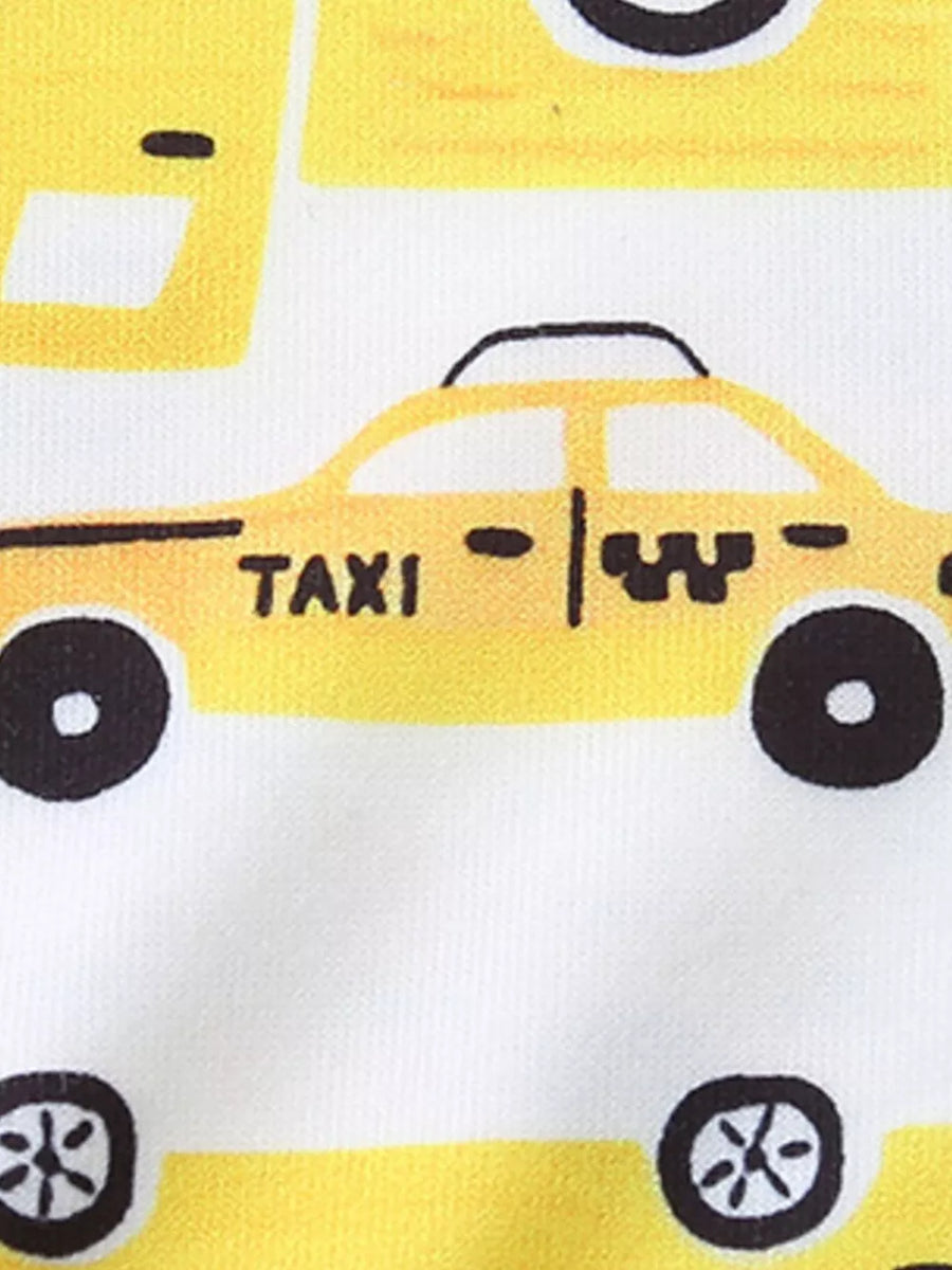 Toddler pajama set with yellow cartoon taxi print on white fabric.
