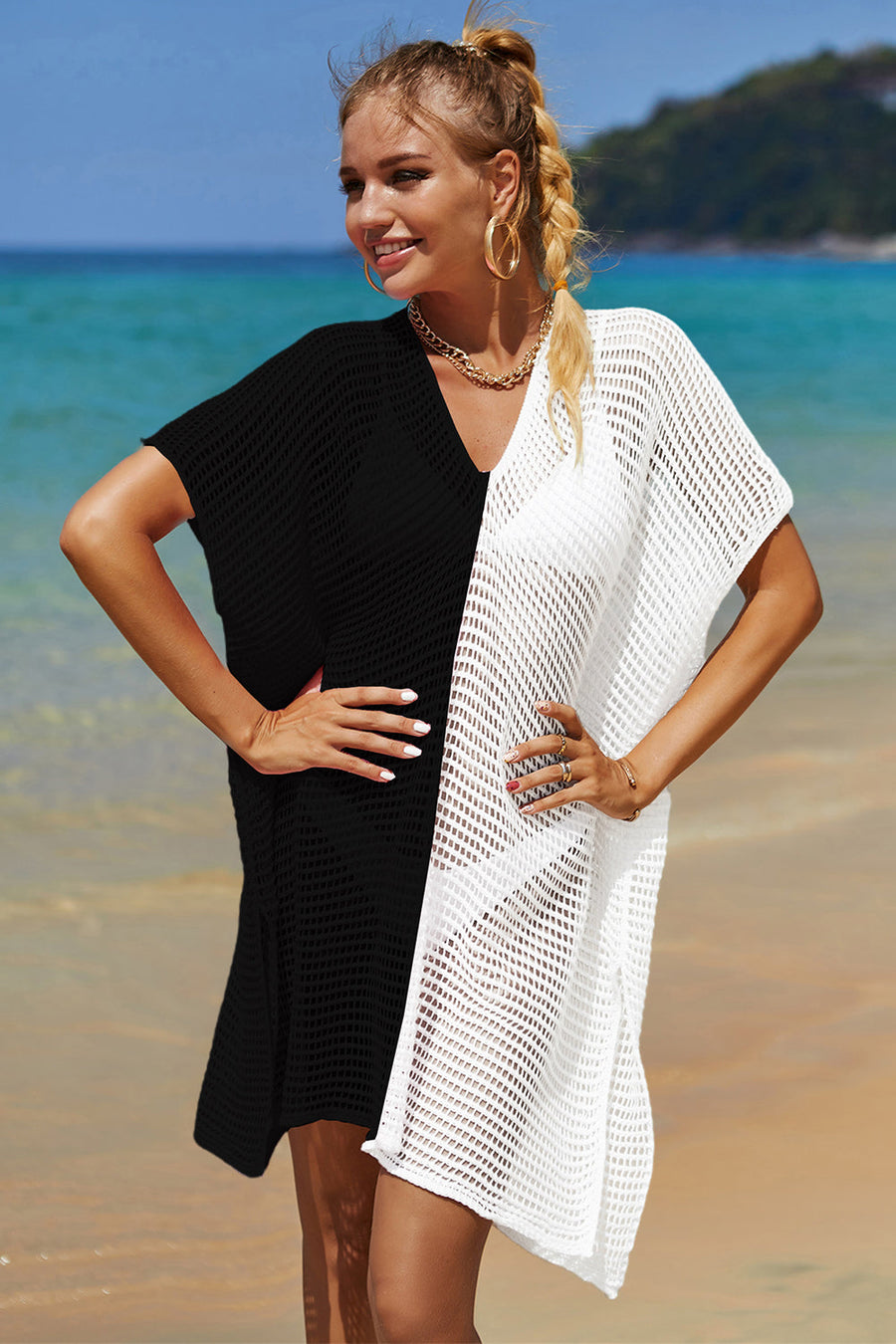 Crochet beach cover-up with black and white color block, V-neck, and short sleeves.