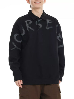 Black oversized polo sweatshirt with gray graphic letter print and button placket.