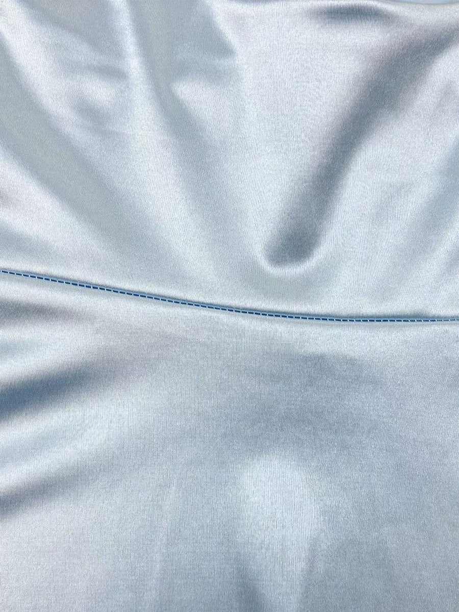Light blue satin fabric with a contrasting blue stitched seam detail.