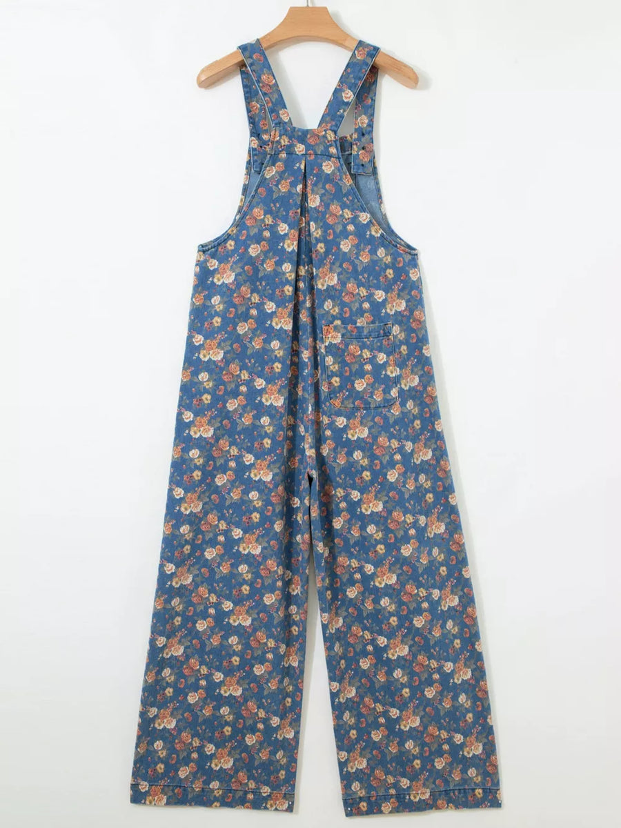 Floral denim overalls with adjustable straps and wide legs.