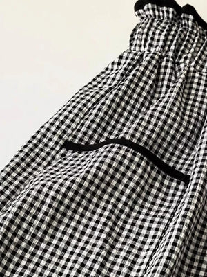 High-waisted wide-leg gingham pants with black trim detail and elastic waistband.
