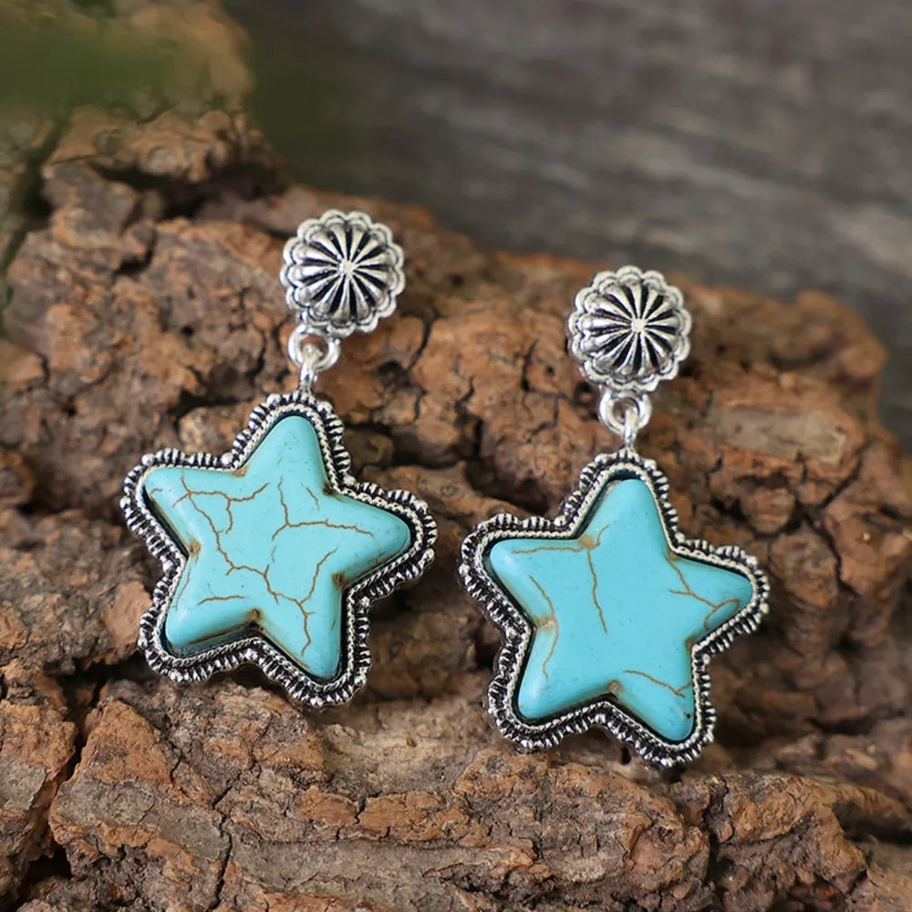 Southwestern starburst drop earrings in sky blue with cracked stone detail and silver alloy setting.