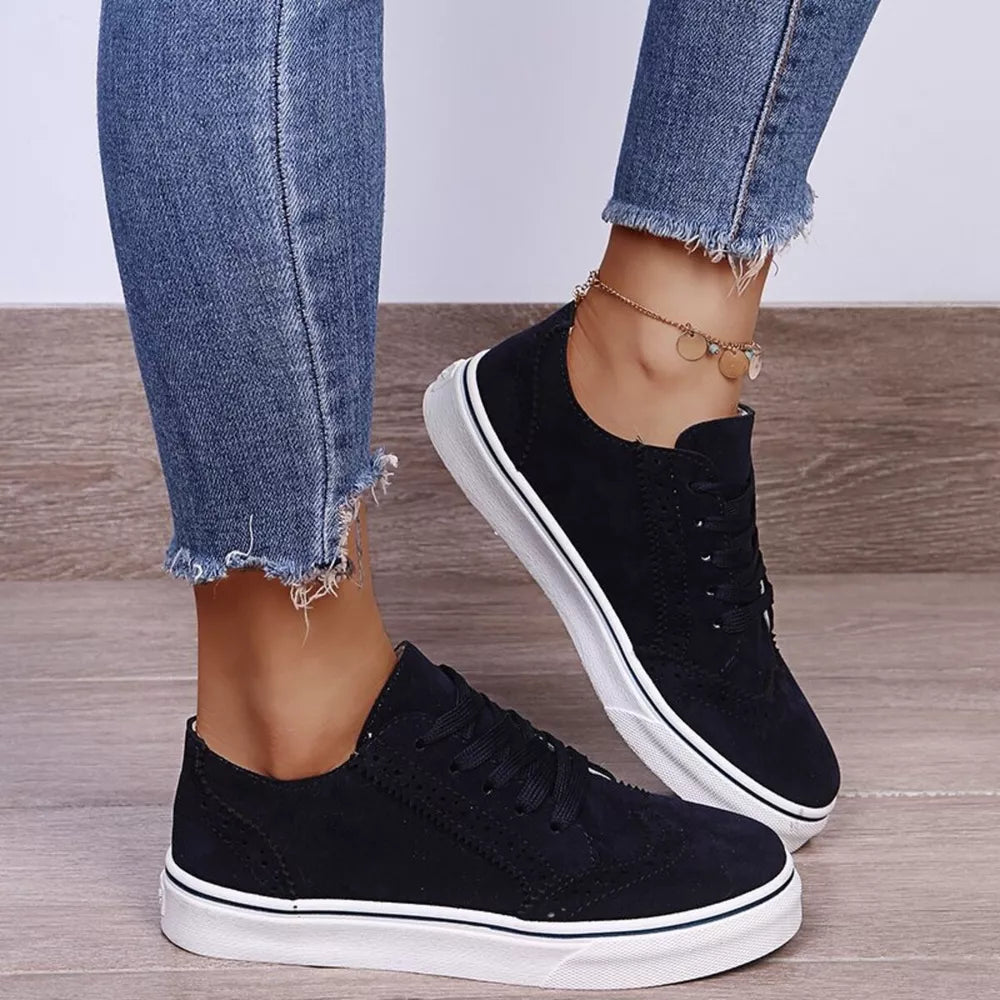 Black matte finish lace-up sneakers with white soles and subtle perforated details.