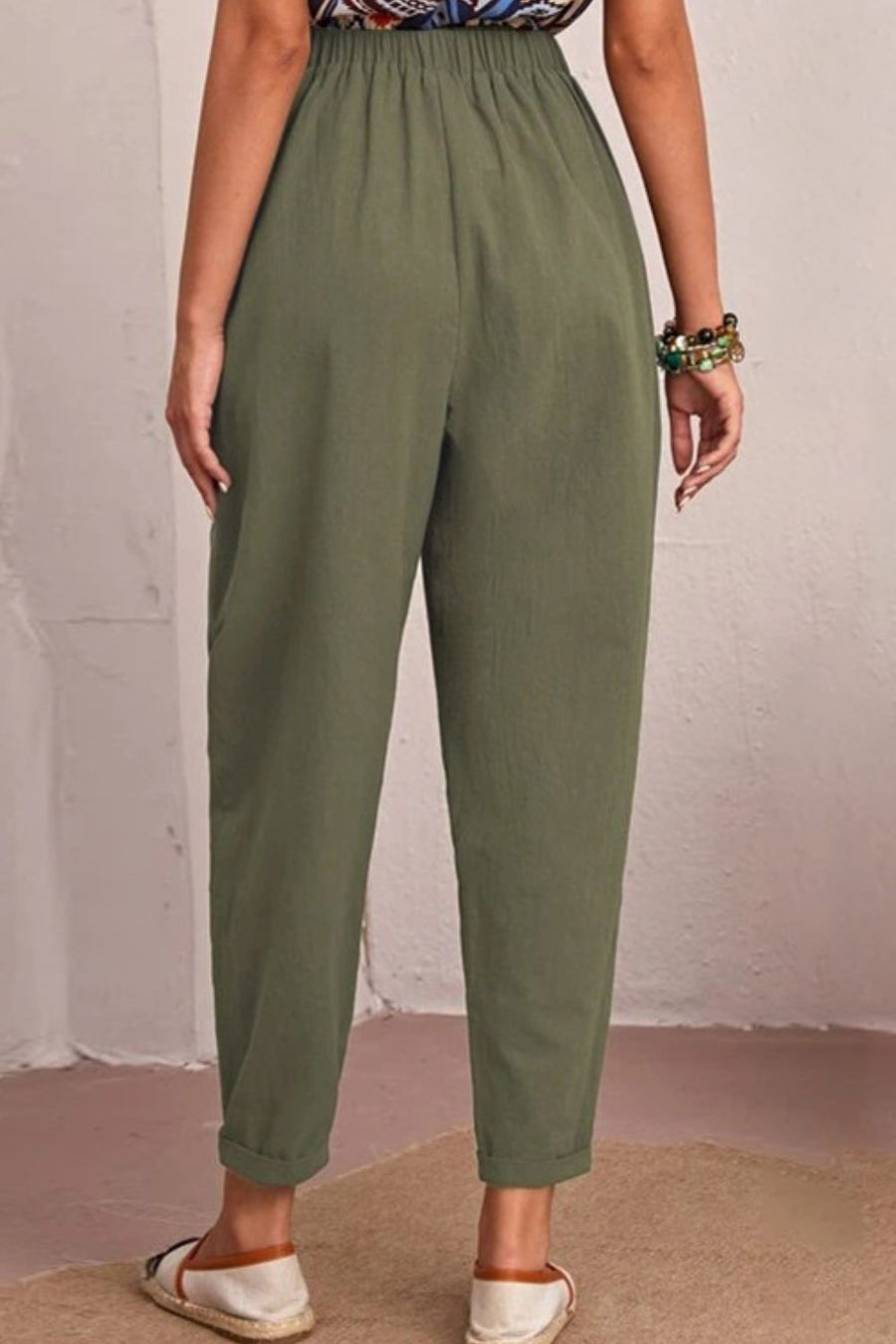 Relaxed linen tapered trousers in matcha green with elastic waist and cuffed hem.