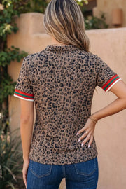 Leopard print half-zip shirt with striped sleeves.