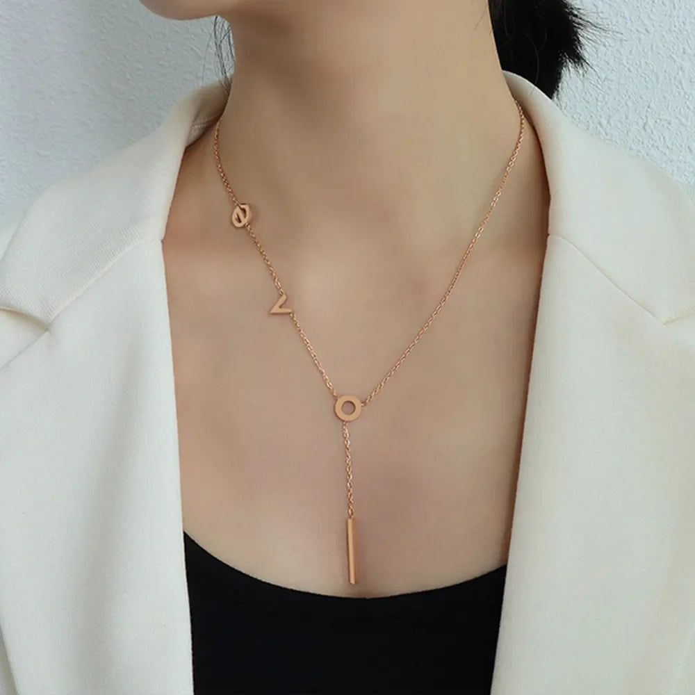 Rose gold Love Letter pendant necklace with bar drop detail.