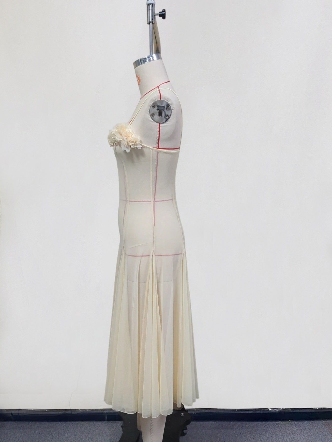 Cream chiffon maxi dress with floral bust detail and pleated skirt