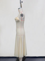 Cream chiffon maxi dress with floral bust detail and pleated skirt