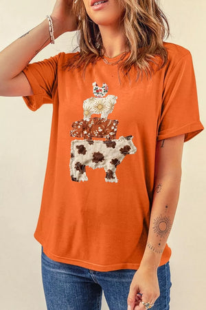 Orange graphic tee with stacked cow, sheep, and chicken applique design.
