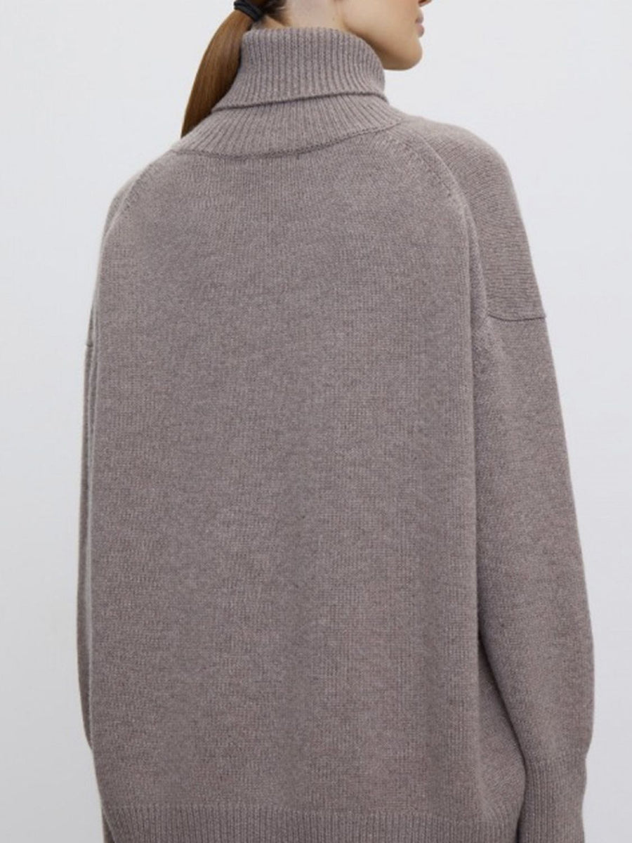 Relaxed turtleneck sweater in Dust Storm acrylic with sculptural sleeves and ribbed cuffs.