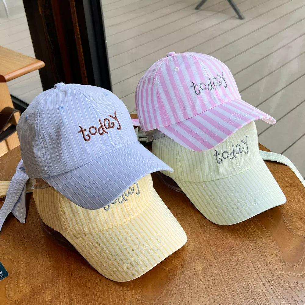 Pastel striped cotton baseball caps in pink, blue, and yellow, each embroidered with "today".