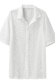 White crochet resort shirt with geometric pattern, short sleeves, and button-up front.