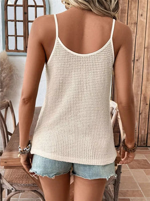 Cream waffle knit camisole with spaghetti straps and lace trim detail.