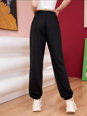 Black sweatpants with elastic cuffs and drawstring waist, featuring butterfly embellishments.