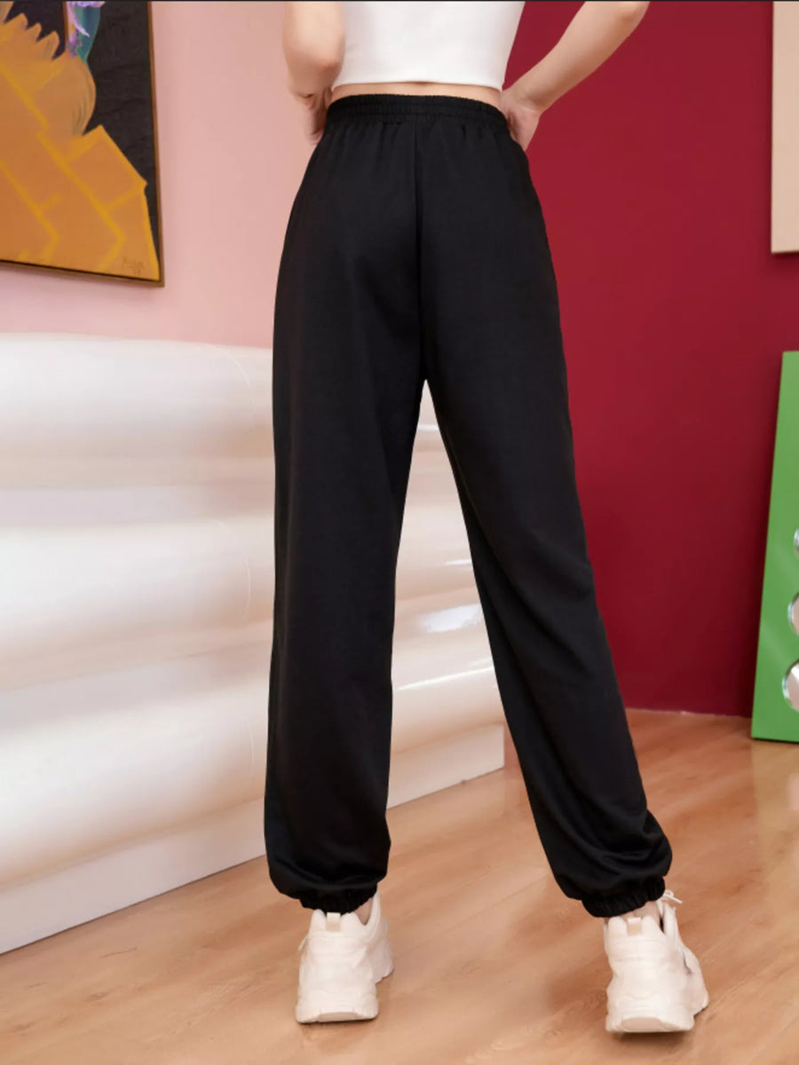 Black sweatpants with elastic cuffs and drawstring waist, featuring butterfly embellishments.