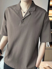 Taupe cotton polo shirt with embroidered detail and buttoned collar.