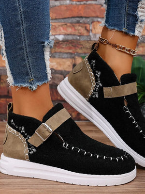 Black textured stitch-detail buckle sneakers with tan accents and white soles.