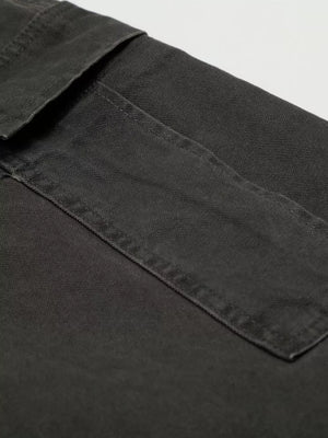 Grey cargo pants with flap pocket detail and visible stitching.