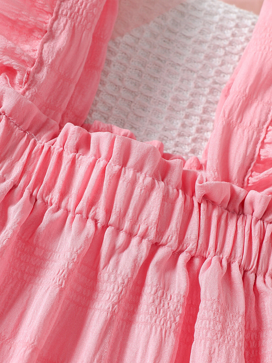 Pink baby top with ruffled trim and smocked neckline detail