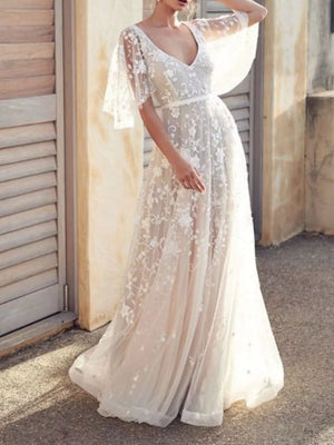 White lace flutter sleeve v-neck maxi dress with floral embroidery and sheer overlay.