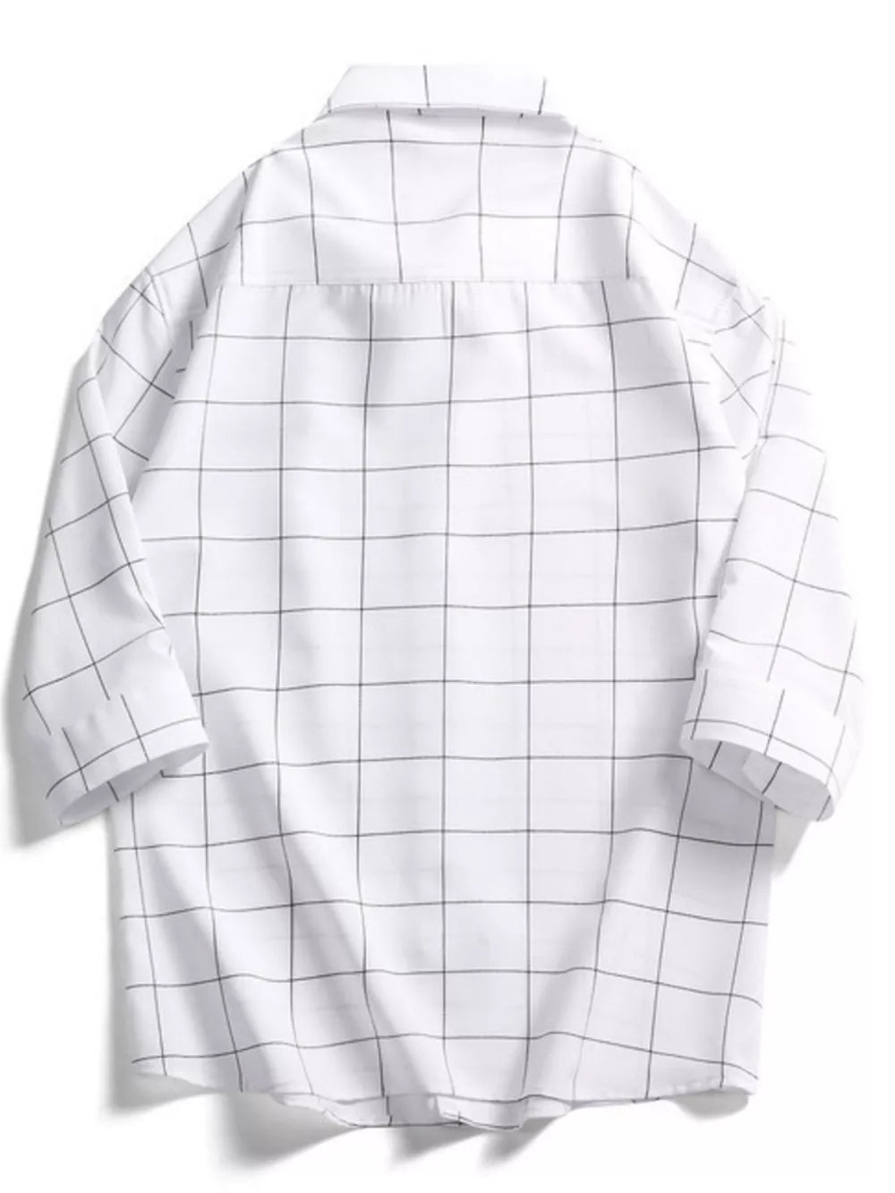 White oversized cotton button-down shirt with black plaid print and collar.