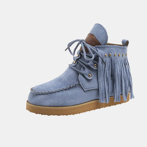 Blue suede moc-toe ankle boots with fringe and lace-up closure.